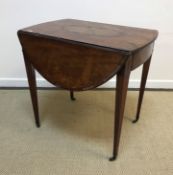An early 19th Century mahogany and inlaid oval drop-leaf Pembroke table with fan marquetry inlaid