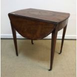 An early 19th Century mahogany and inlaid oval drop-leaf Pembroke table with fan marquetry inlaid