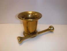 A 19th Century Russian brass mortar of inverted bell form with ring decoration to the flared rim,