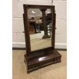 A 19th Century mahogany toilet mirror, the rectangular plate on a three drawer base with ogee