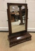 A 19th Century mahogany toilet mirror, the rectangular plate on a three drawer base with ogee