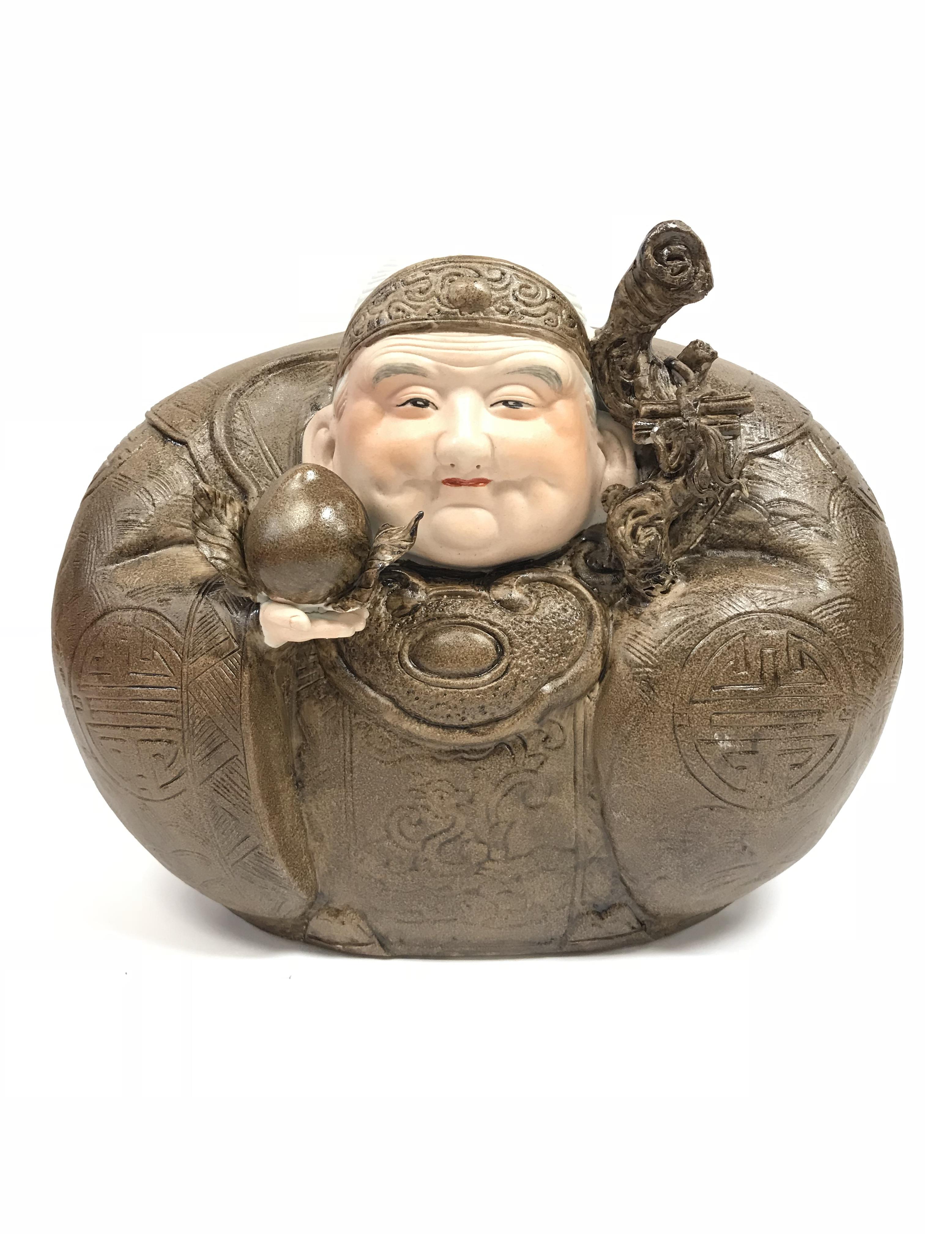 A contemporary Chinese glazed porcelain figure of a seated Buddha, a peach in his right hand, a root - Image 2 of 2