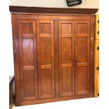 A mahogany cupboard / gun cabinet, the moulded cornice above two pairs of triple panelled doors