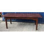 A 19th Century French stained pine farmhouse kitchen table, the four plank top with cleated ends