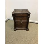 A Victorian oak chest with double fielded rising top over three drawers flanked by column supports