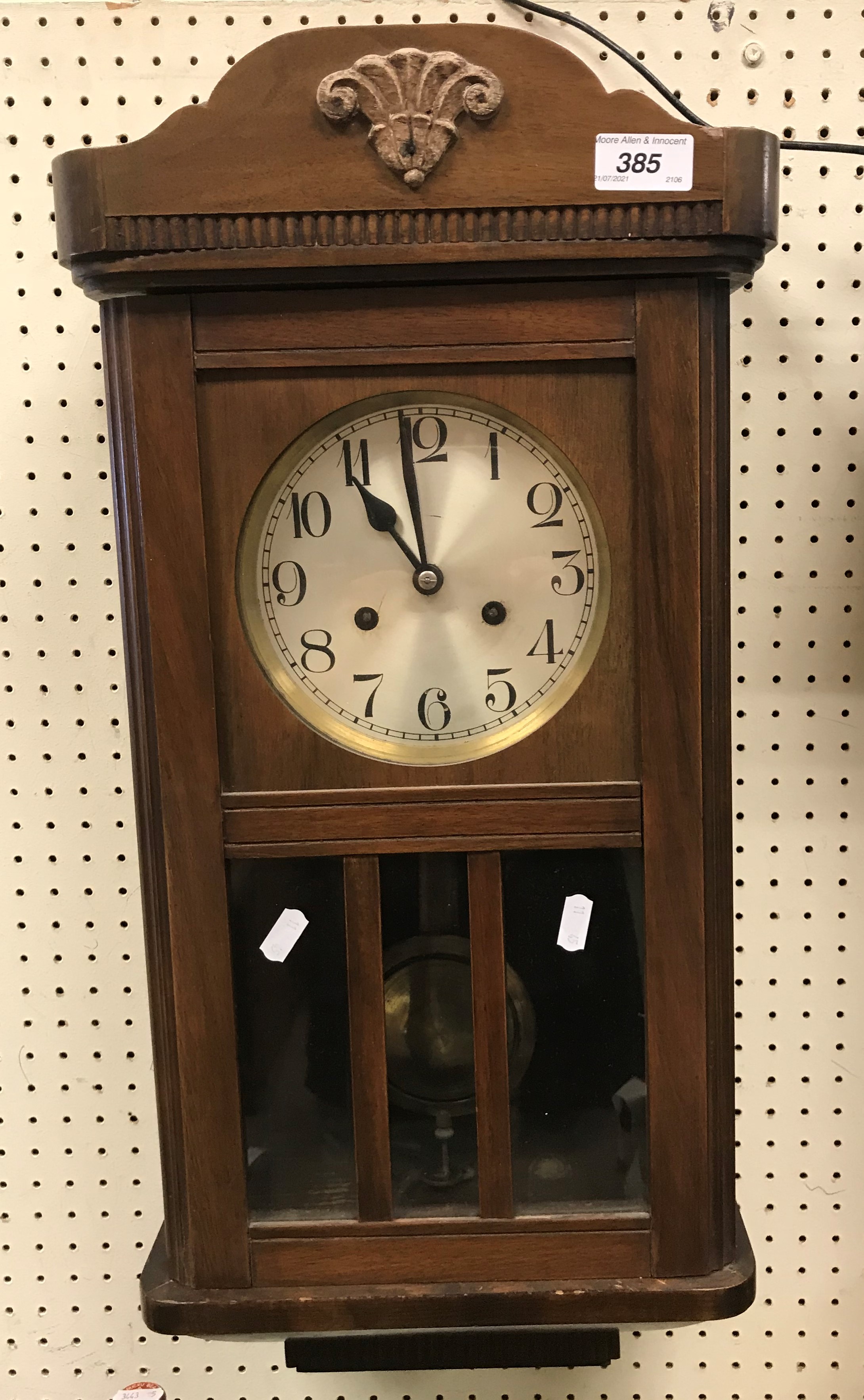 A mid 20th Century walnut cased drop dial wall clock, the eight day movement with silvered dial