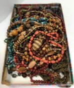 A boxed collection of various costume jewellery including necklaces, brooches, rings, simulated bone