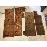 A collection of five various Ushak carpet fragments of an orange, green and yellow colour