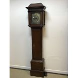 An oak cased long case clock, the caddy top with blind fretwork frieze over a plain main body, the