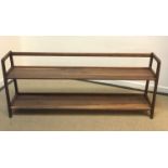 A modern walnut two tier open book shelf bearing label to underside "Agnes Long in walnut by Kay &