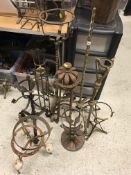 Eleven various stands including oil lamp stands, bowl stands, etc. in brass and/or iron