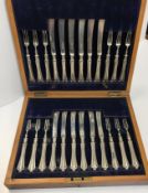 A cased set of twelve Edwardian silver fruit knives and forks (John Round and Son Ltd, Sheffield