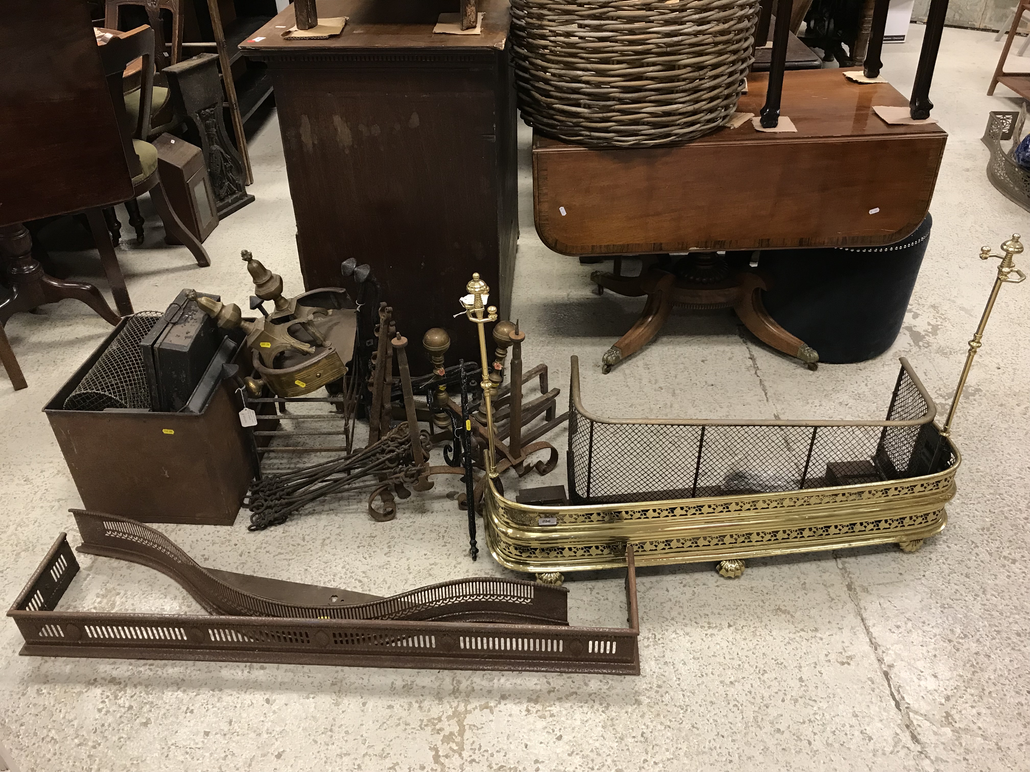 A collection of various fireside accoutrements including a brass fender with integral rests/tools