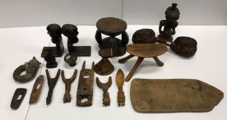 A collection of various ethnographica including pillow or head rest on tripod base, another