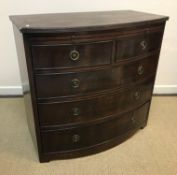 A late 19th Century mahogany bow fronted batchelors chest, the plain top with reeded edge over a