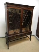 A circa 1900 mahogany display cabinet in the George III taste, the dentil cornice over two lozenge