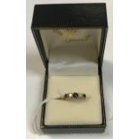 An 18 carat gold ladies dress ring set with three graduated sapphires interspersed by two