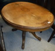 A Victorian walnut and inlaid oval loo table on carved quadruped base to scroll feet and casters 120