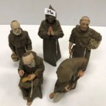 A set of five Algora monks in various poses, the tallest 25 cm