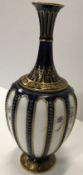 A Royal Worcester blue and gilt decorated stem vase with floral decoration bears blue mark to base