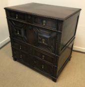 A 19th Century oak chest in the 17th Century Jacobean manner, the plain top with beaded edge over
