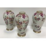 A set of three Samson of Paris urn-shaped vases decorated with armorials and floral sprays, 15 cm