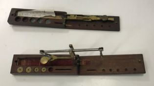 Two mahogany cased sets of sovereign scales bearin