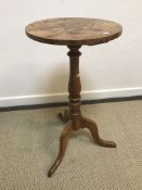 A 19th Century fruitwood occasional table the circular top on a turned baluster pedestal to cabriole