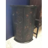 A 19th Century black lacquered and chinoiserie decorated hanging corner cupboard, the two doors