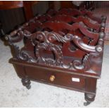 A mahogany four section Canterbury in the William IV manner with four carved dividers over a