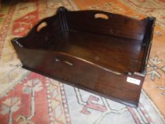 A mahogany butler's tray of rectangular form in the George III style with open handles to each