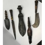 A collection of five various ethnic daggers including a shell embellished leather handled dagger