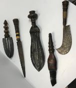 A collection of five various ethnic daggers including a shell embellished leather handled dagger