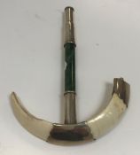 A Burmese white metal mounted boar tusk and jade parasol handle, mounts stamped "S Mc L", 17 cm long