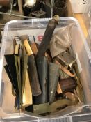 A box of various drawing instruments including rulers, drawing sets, squares, etc.