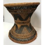 A tribal canework waisted stool, cowrie shell and leather mounted bow, raffia covered wooden handled