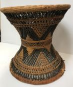 A tribal canework waisted stool, cowrie shell and leather mounted bow, raffia covered wooden handled