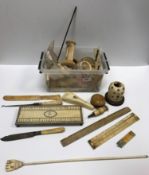 A box containing various mainly 19th Century ivory and bone artifacts including a circular snuff box