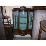 An Edwardian mahogany and inlaid display cabinet with barber pole stringing throughout, the