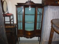 An Edwardian mahogany and inlaid display cabinet with barber pole stringing throughout, the