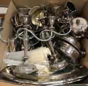 A box of assorted plated wares to include a pair of three branch candelabra, various serving