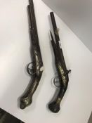 Two 18th Century carved walnut flintlock pistols (one with flintlock action missing) together with a