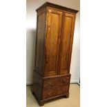 A modern oak linen press in the 18th Century manner, the moulded dentil cornice over two panelled