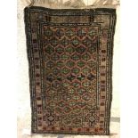 A Turkish prayer rug, the central panel set with repeating motifs on a pink ground within a