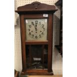 A 1930s mahogany cased drop dial wall clock with musical movement 73 cm high and a modern yew wood