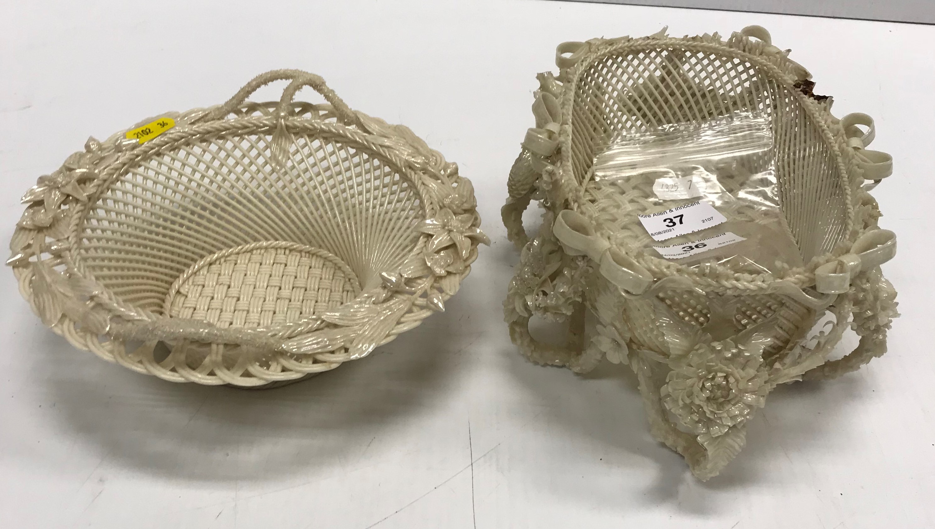 A Belleek oval basket with all-over ribbon tied an