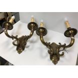 A pair of modern lacquered brass twin branch wall lights of scrollwork form in the Rococco style