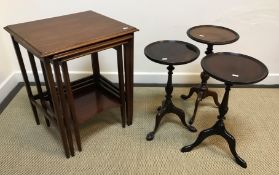 An Edwardian mahogany nest of three occasional tables, the plain tops with moulded edge on square