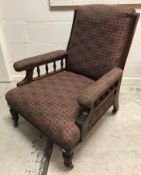 A Victorian mahogany framed upholstered armchair, the swept arms with rail decoration raised on