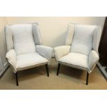 A pair of Ligne Roset "TOA" wing back armchairs on